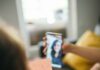 Four users, zero churn: situated software returns A child holds up a drawing to a phone propped on a table during a video call with a relative, in a living room