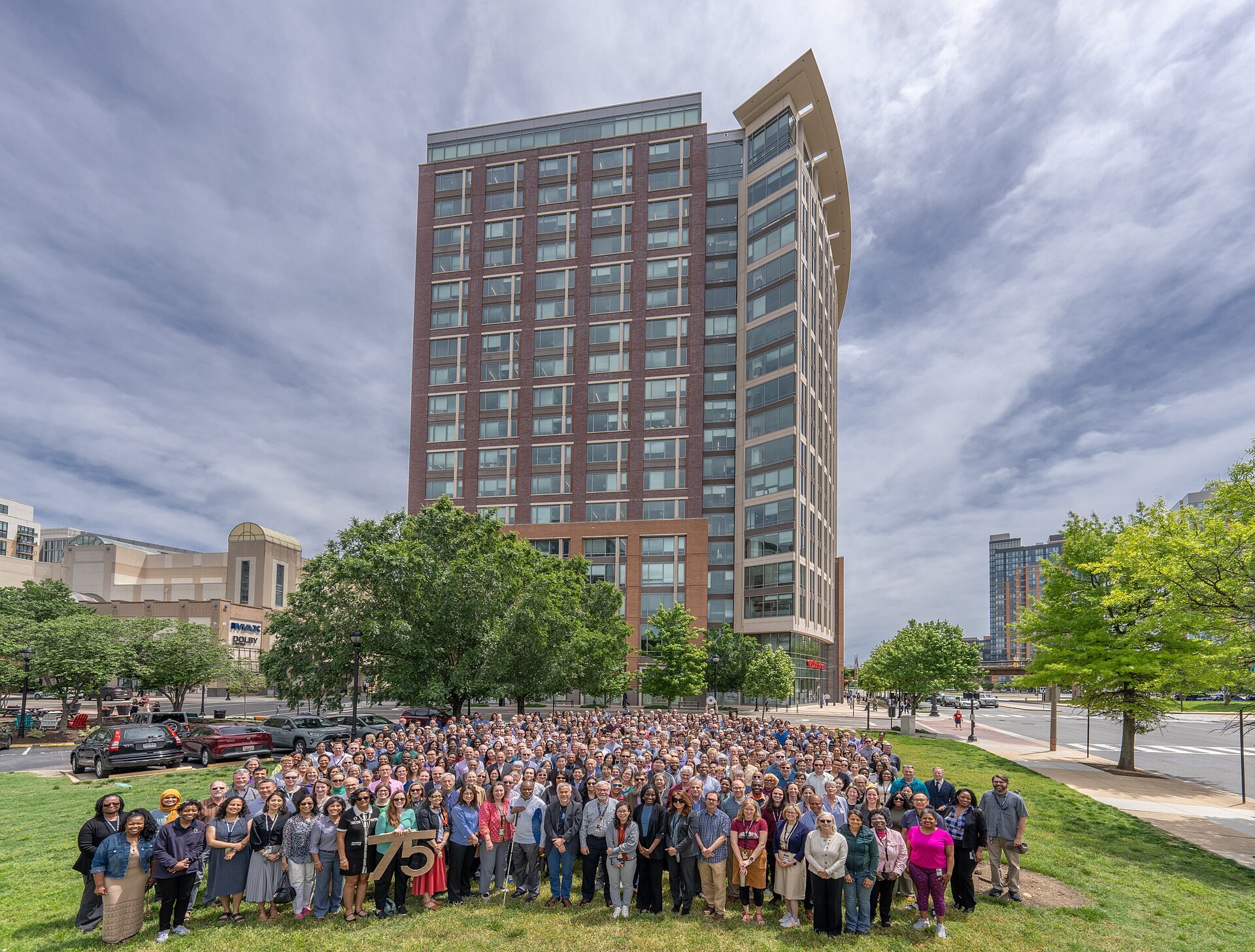 Hundreds of employees pose in front of the National Science Foundation tower.
