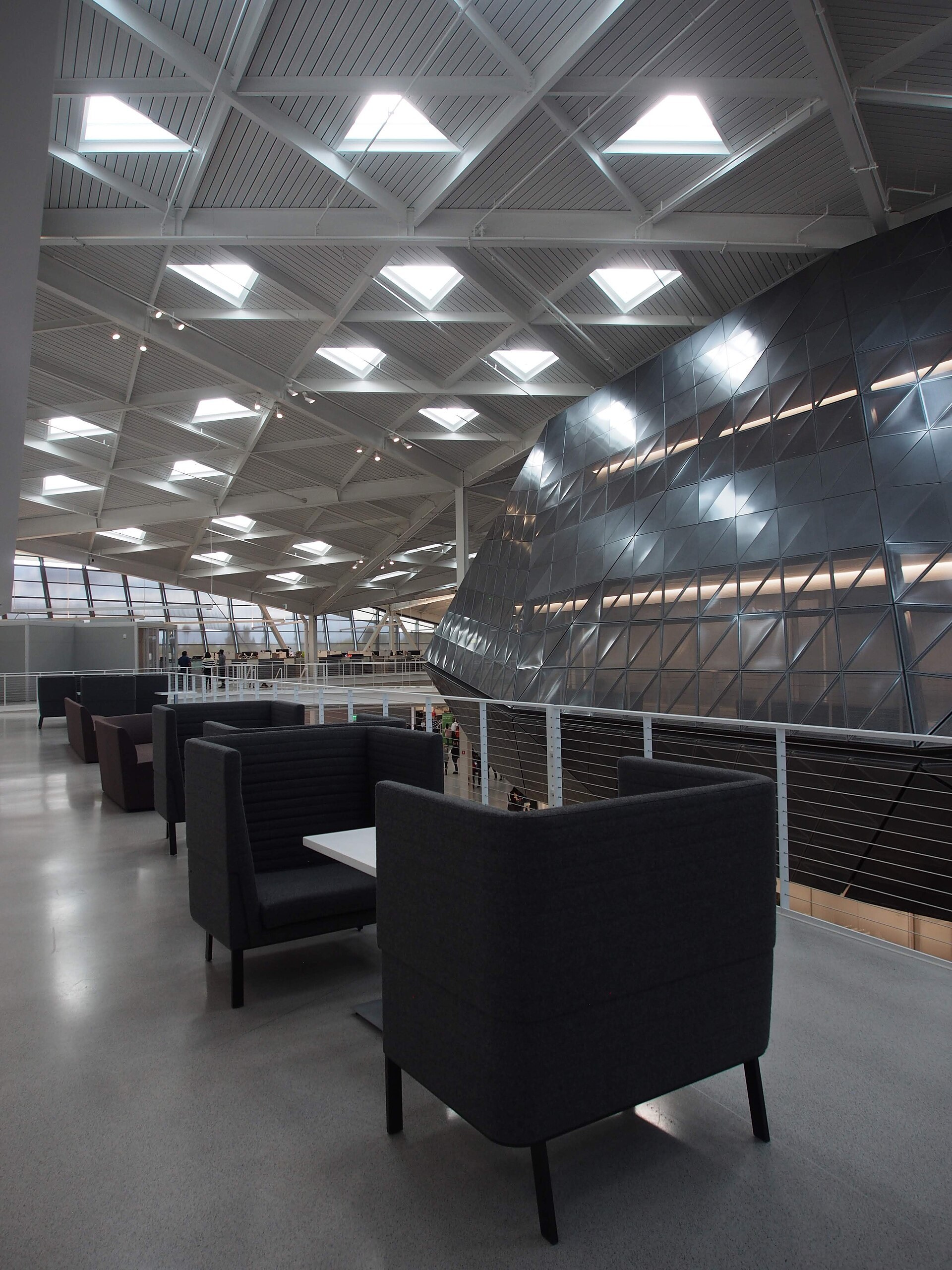 The bright atrium of Nvidia's Endeavor building, with armchairs and a cocoon-shaped structure.