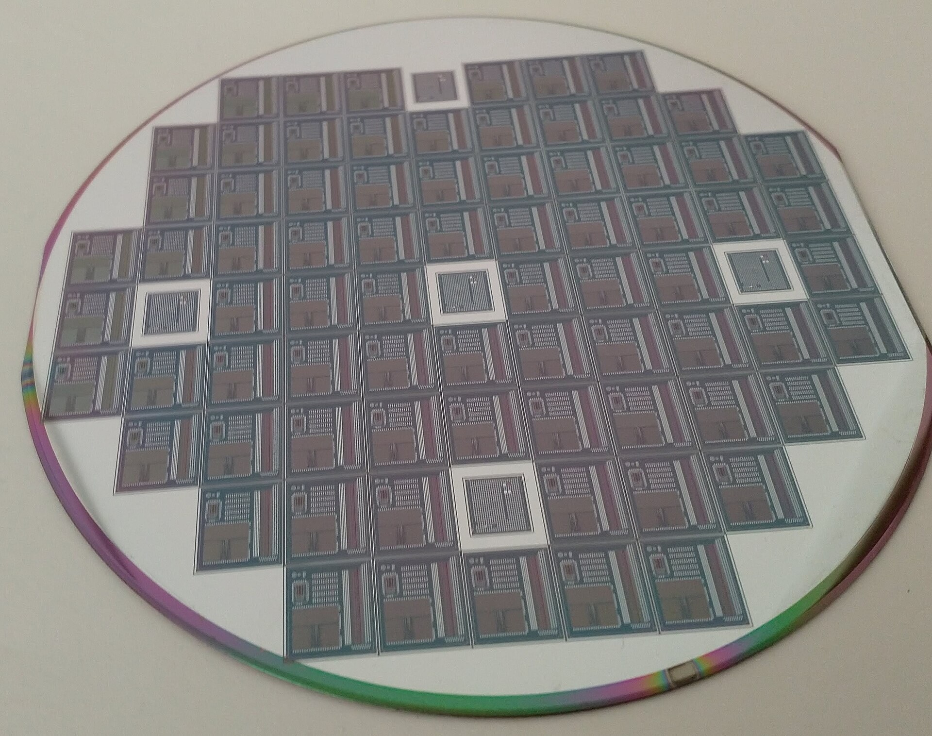 A silicon wafer covered with many small, different circuits.